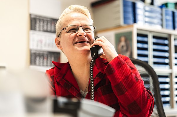 A laughing woman on the phone